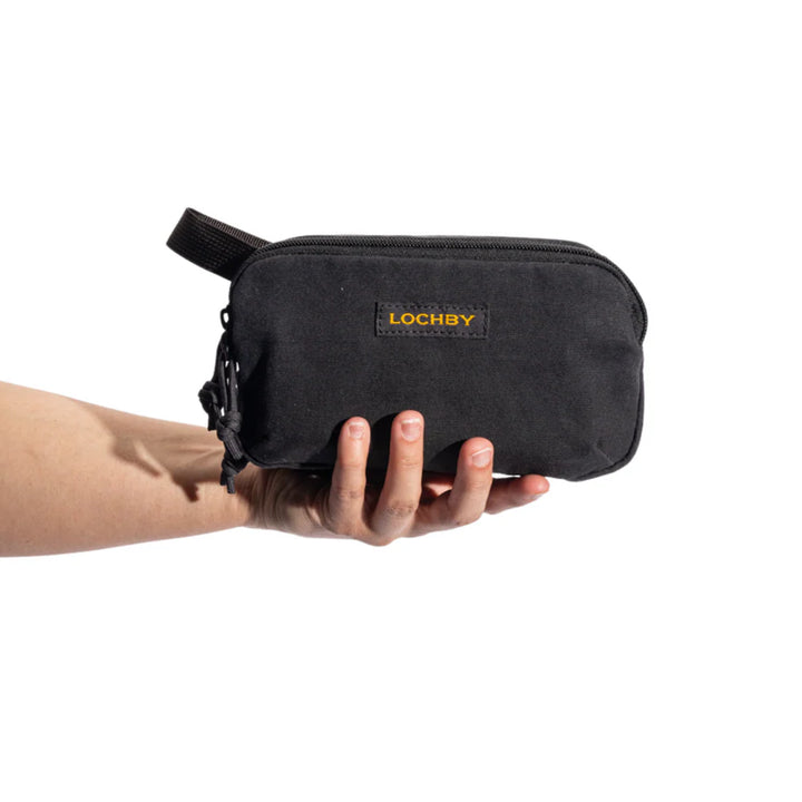 Black pouch held by a hand with 'LOCHBY' branding on a white background
