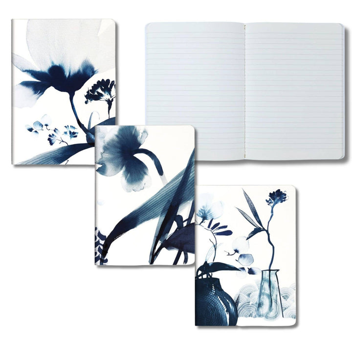 Floral design notebooks and a journal on a white background