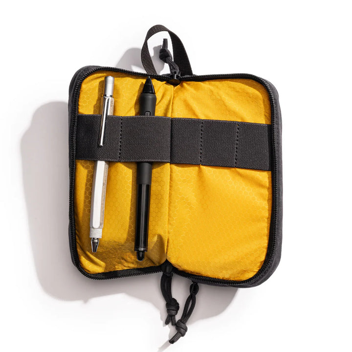 Yellow case with black interior holding two pens on a white background