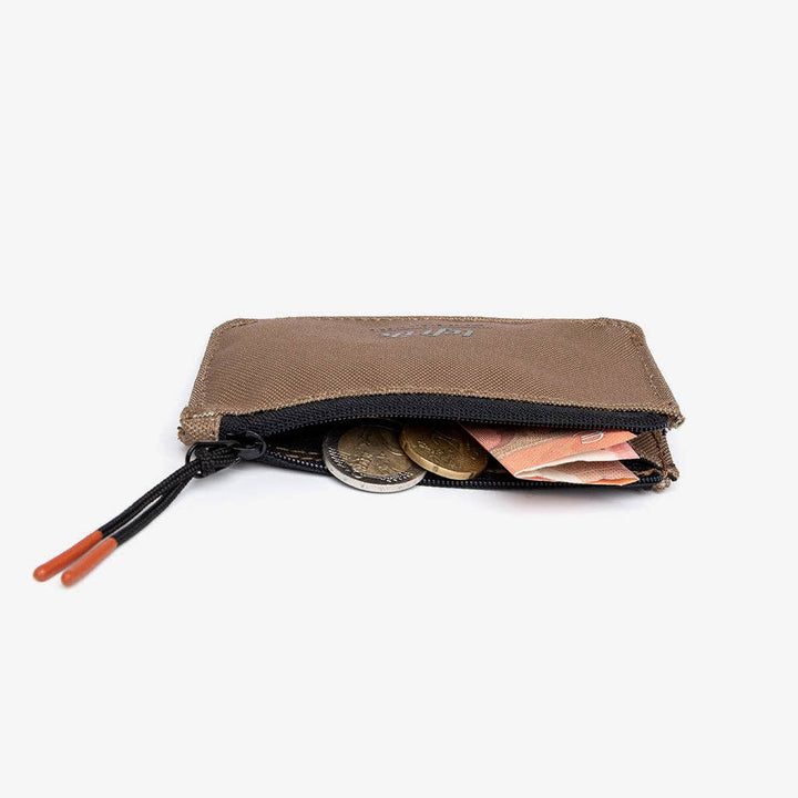 Brown coin purse with coins and money on a white background