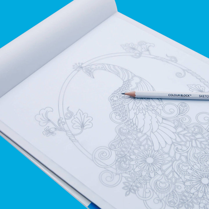 Open notebook with intricate mandala design and a pencil on a blue background