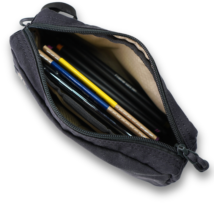 Black pouch with colorful pencils inside on a white background