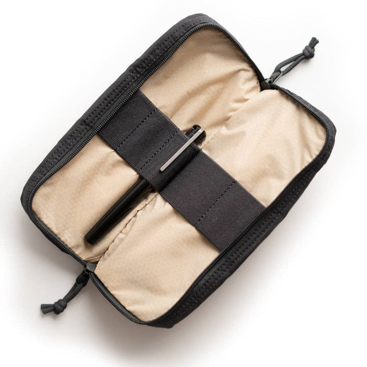 Black travel pouch with beige interior on a white background