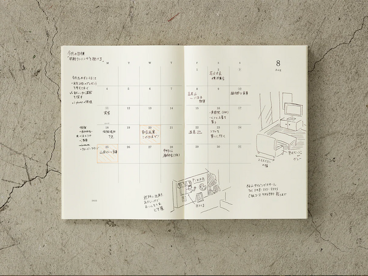 Open monthly calendar with architectural drawings on a textured surface