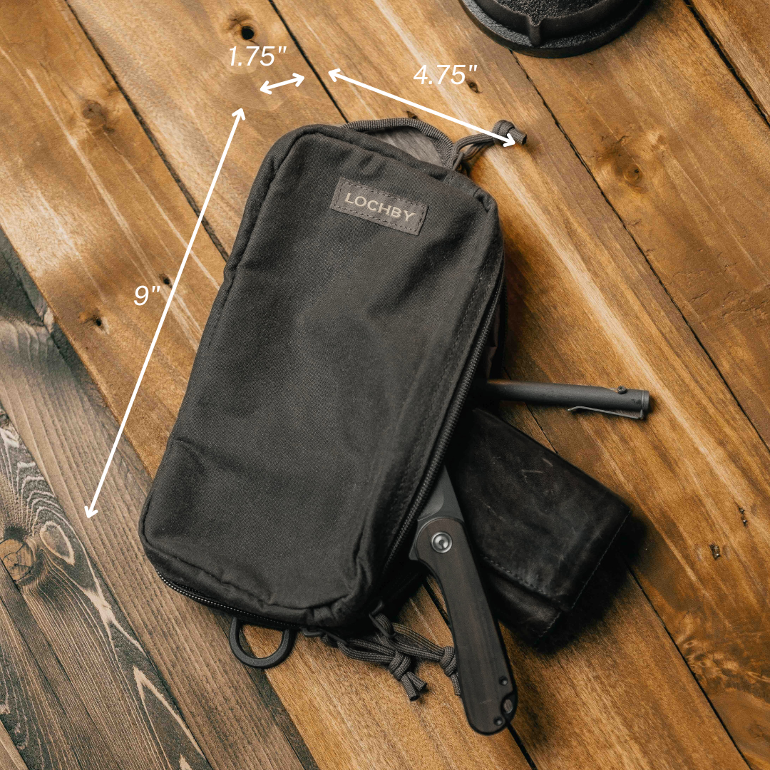 Black pouch with measurements and a knife on a wooden surface, featuring the brand 'LOCHBY'.