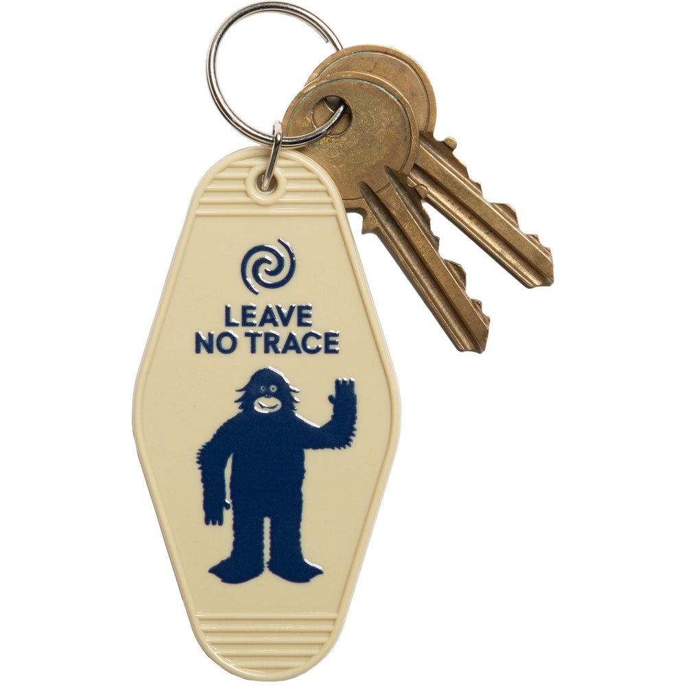 Keychain with 'Leave No Trace' and Bigfoot design on a beige background
