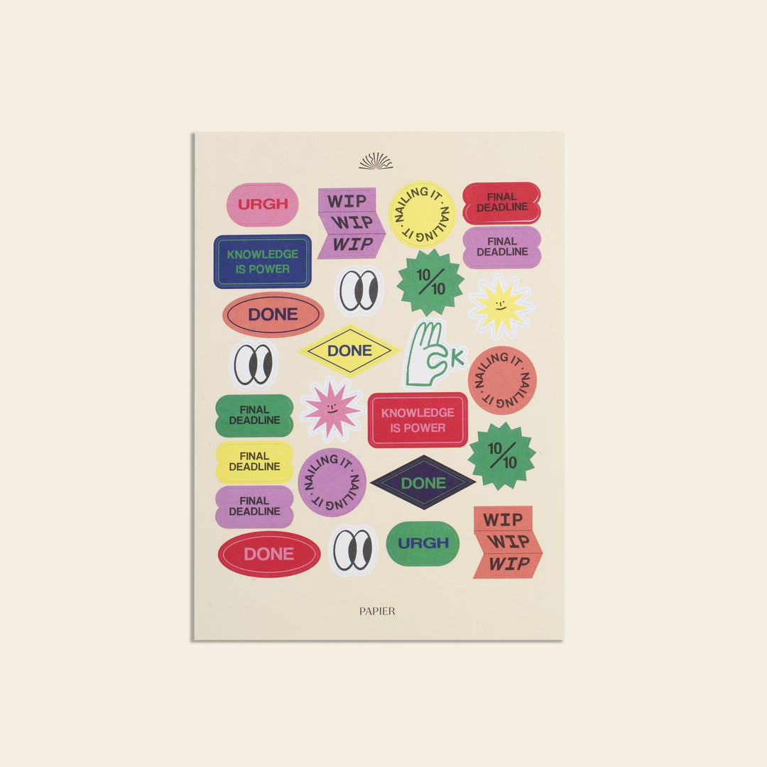 Beige notebook with colorful stickers on a beige background