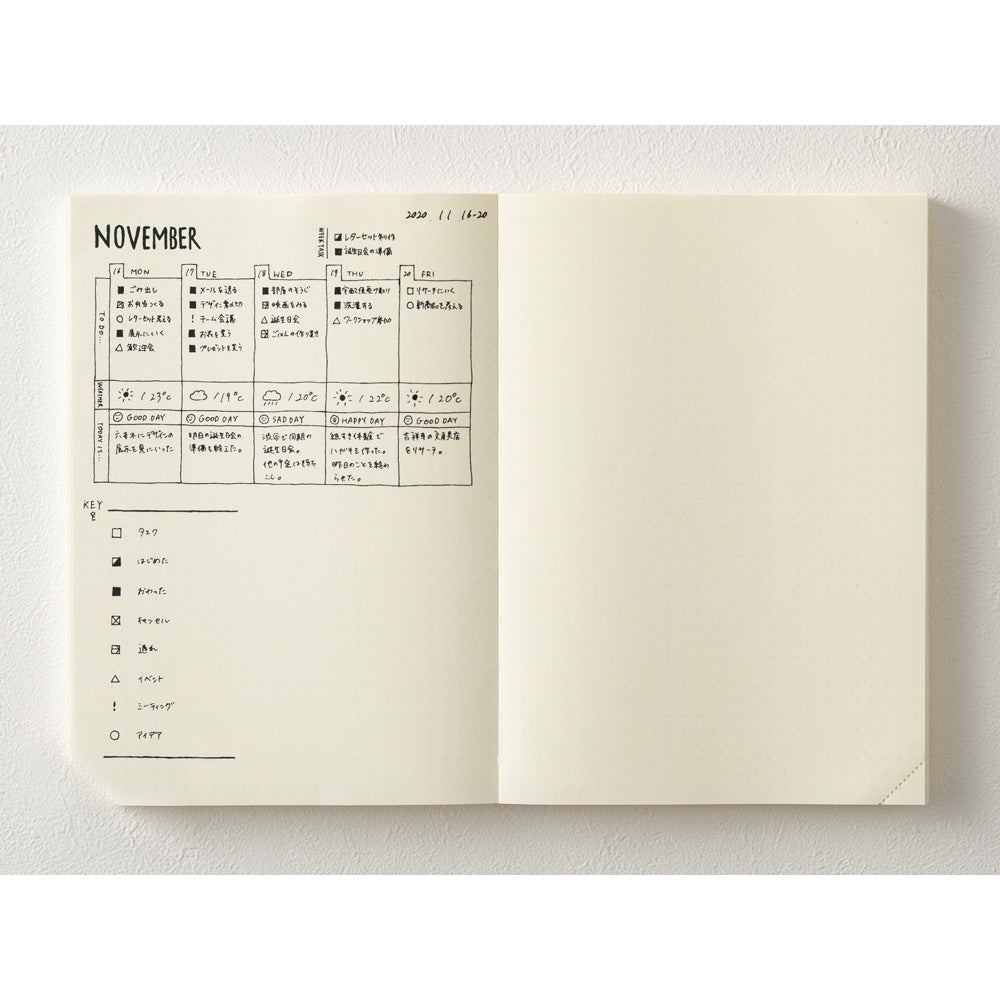 Open notebook showing a calendar for November on a white background