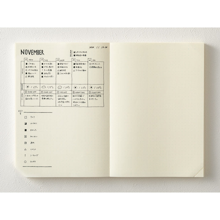 Open notebook showing a calendar for November on a white background