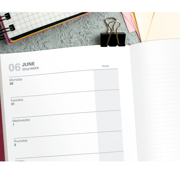 Open planner with a page showing June 6th on a desk with office supplies.