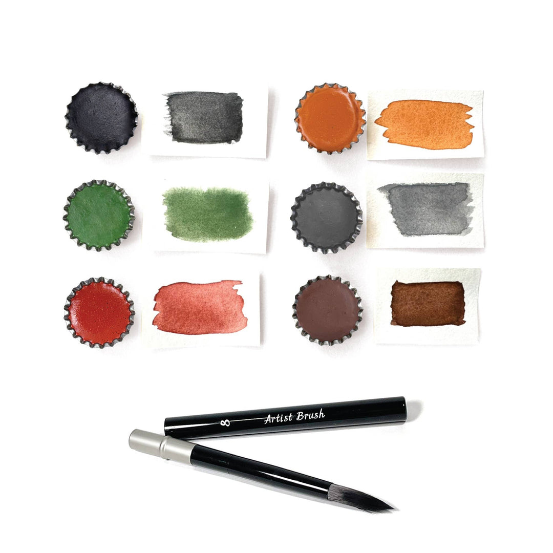 Set of watercolor paint samples with brushes on a white background