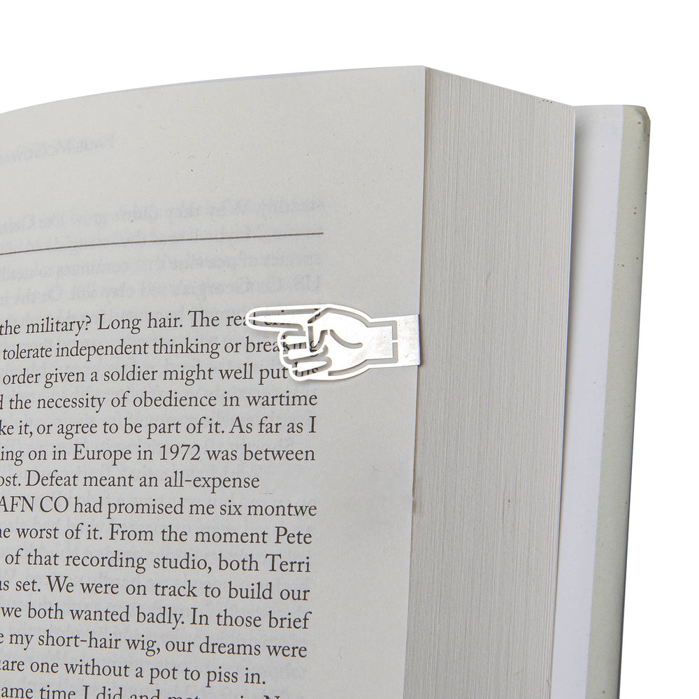 Metal bookmark shaped like a hand on an open book