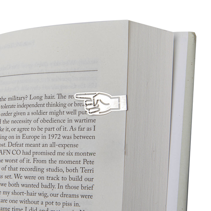 Metal bookmark shaped like a hand on an open book
