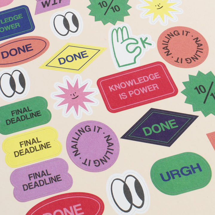 Collection of colorful stickers with various phrases on a beige background