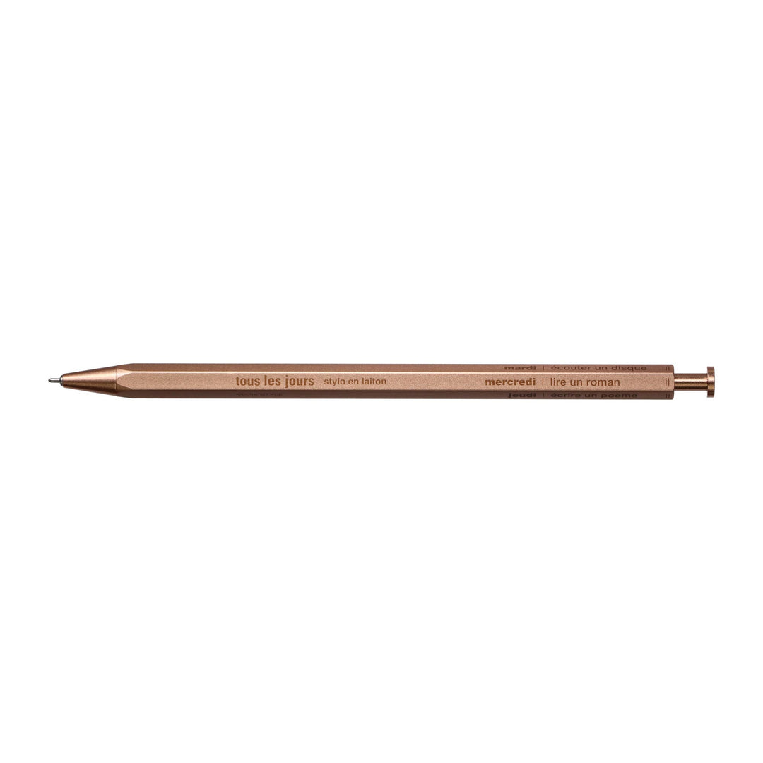 A selection of ballpoint pens with brass bodies, available in gold, silver, and rose gold colors, displayed alongside their packaging boxes.