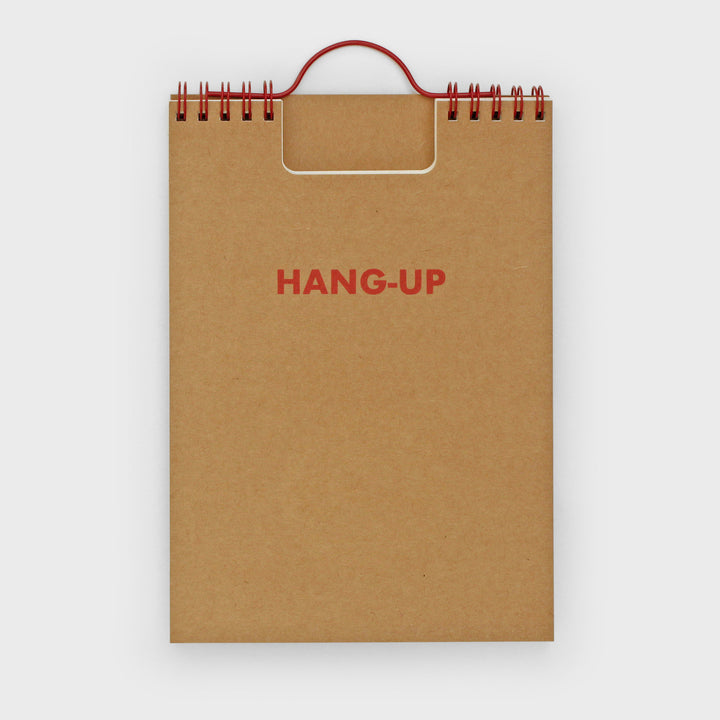 Brown notebook with 'HANG-UP' text on a white background