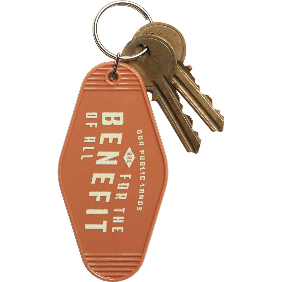 Keychain with keys and 'For the Benefit of All' tag on a white background