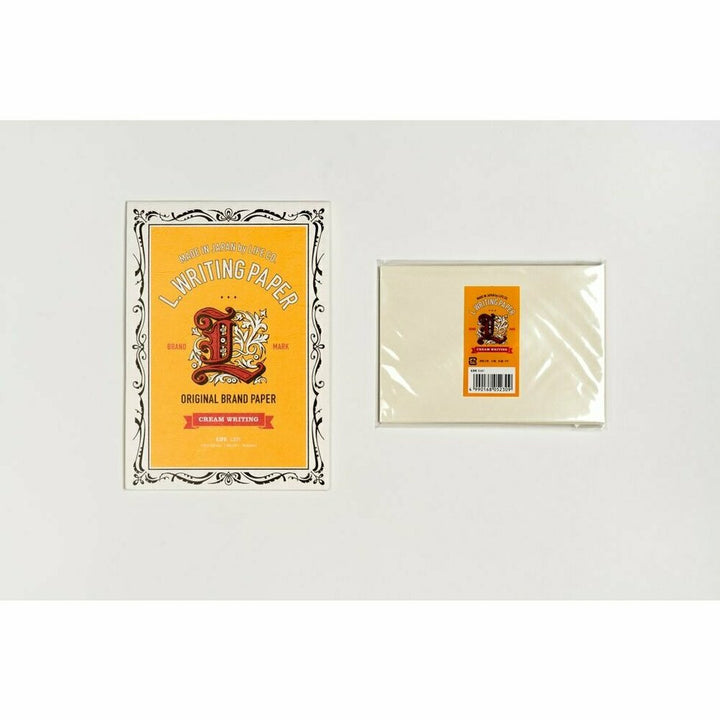 Writing pad and envelope set with decorative yellow label on a white background