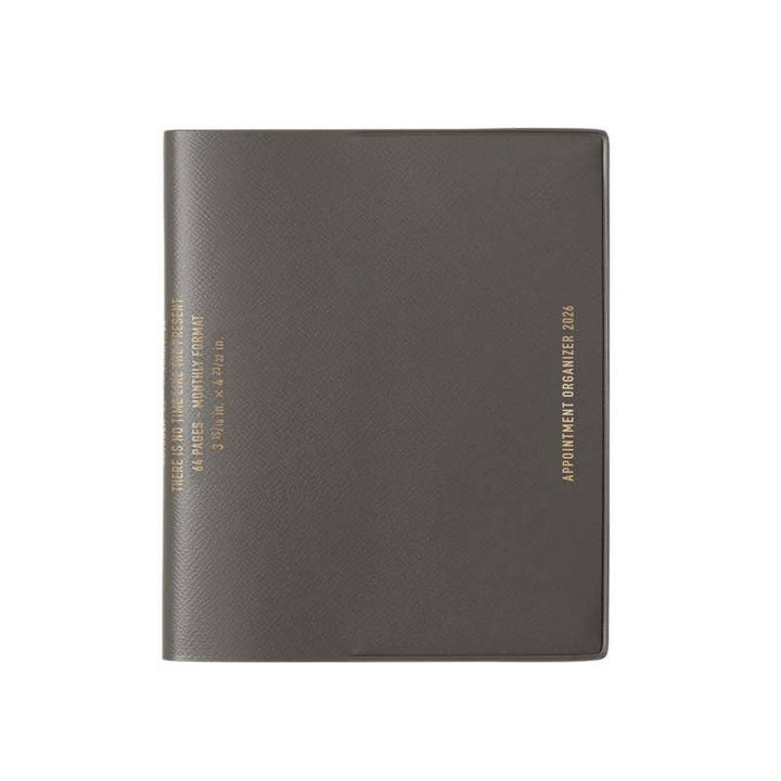 Dark gray planner with gold text on a white background