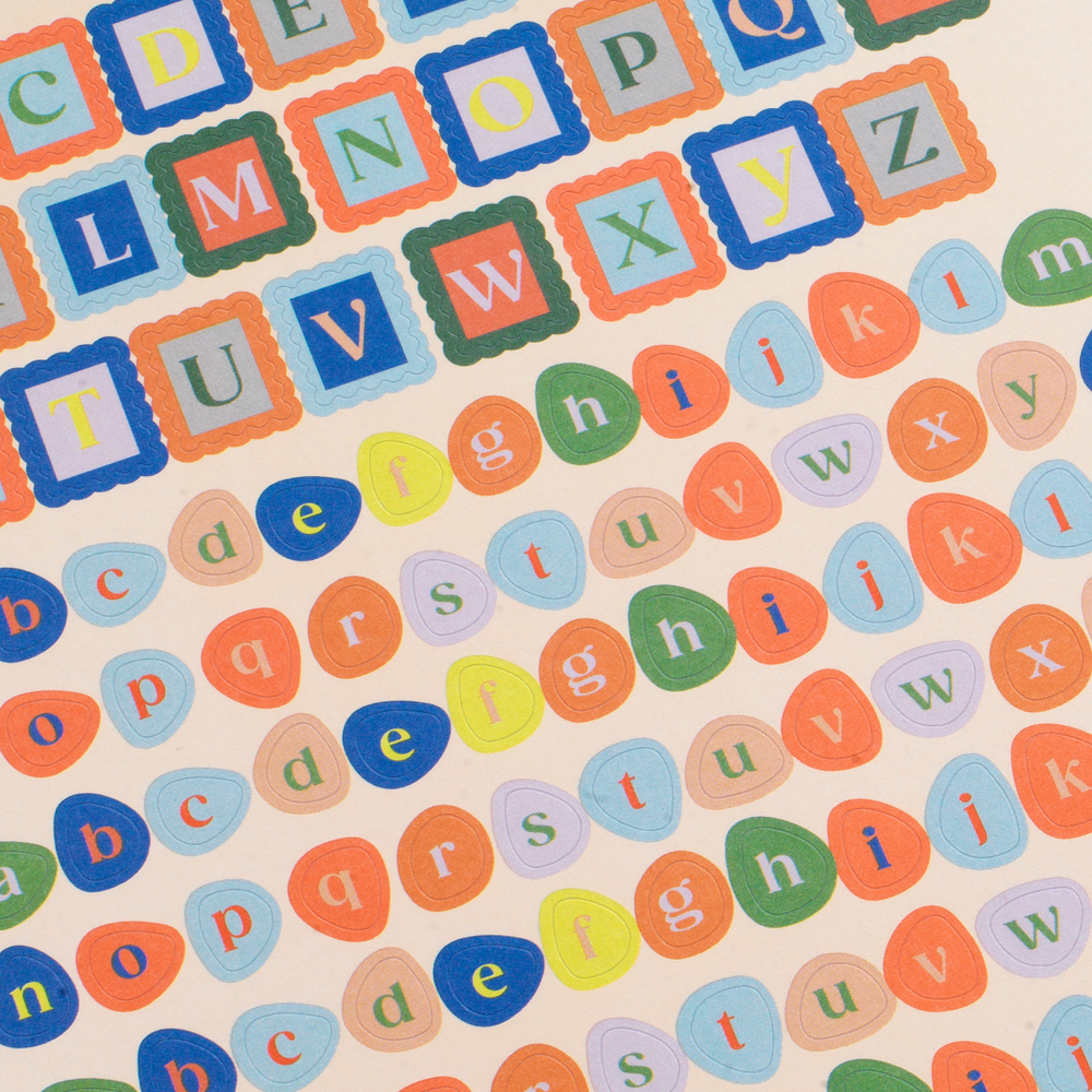 Colorful alphabet letters on a beige background