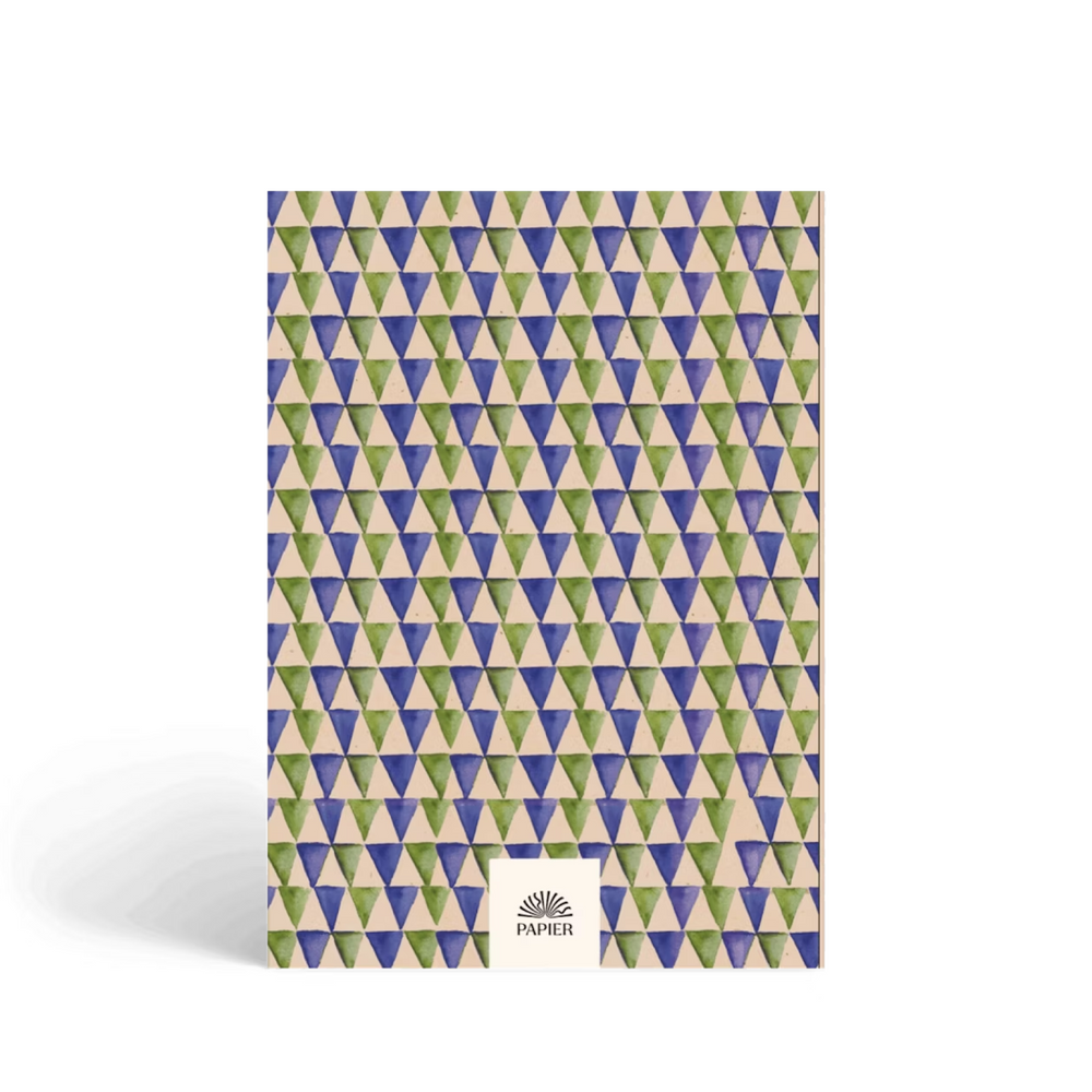 Book with geometric triangle pattern on a white background.