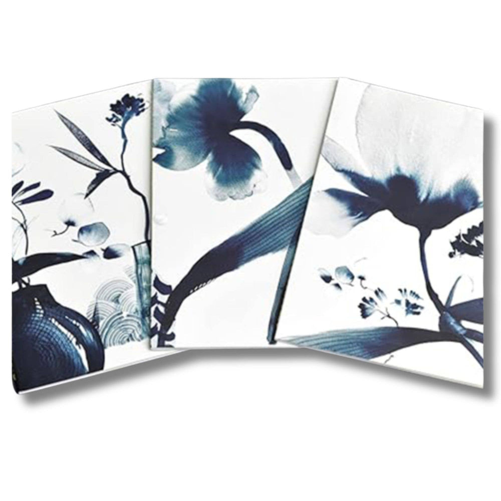 Set of three decorative notebooks with blue floral designs on a white background