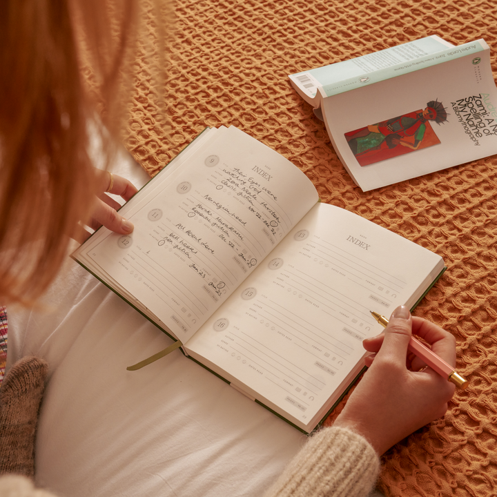 Person flipping through a book on a textured surface