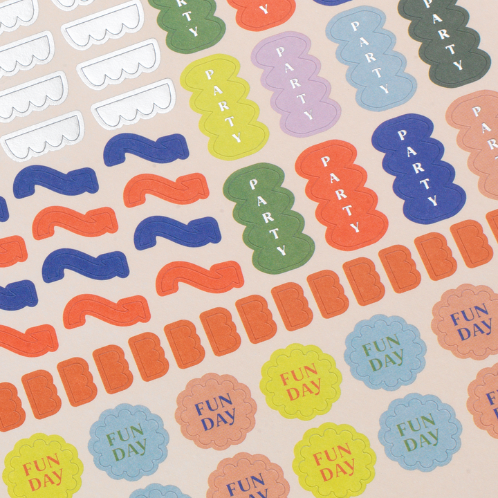 Colorful 'Party' and 'Fun Day' stickers on a beige background
