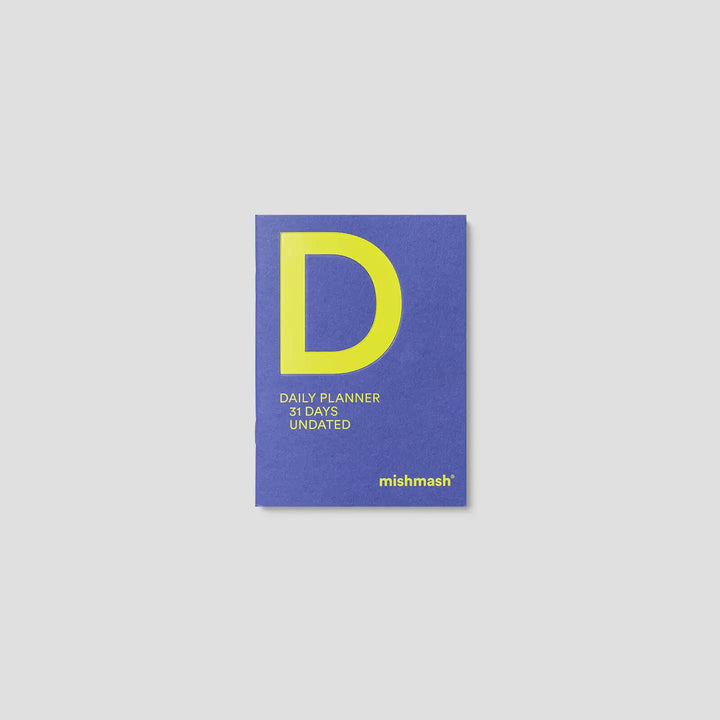 Blue daily planner with yellow 'D' and 'mishmash' branding on a light gray background