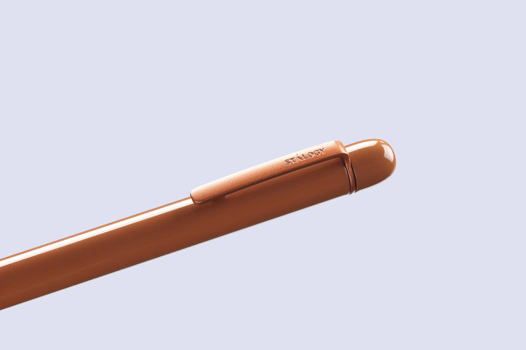 Brown pen on a light blue background