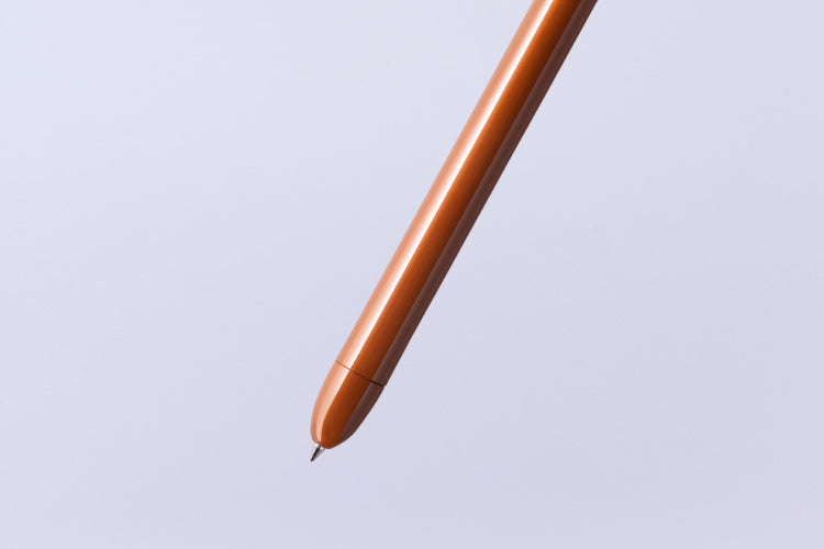 Close-up of a brown pen on a light gray background