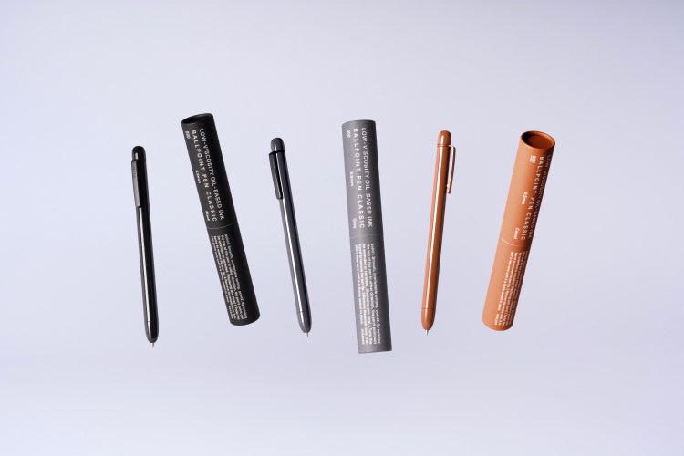 Set of pens and their packaging on a light gray background