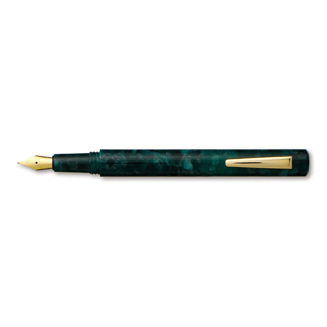 Green marble fountain pen with gold accents on a white background