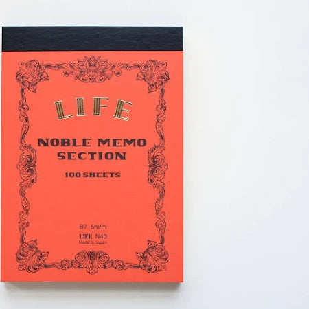 Orange notebook with decorative text on a white background.