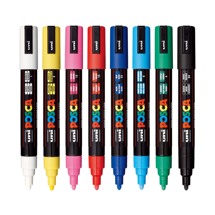 Set of Uni Posca markers in various colors on a white background